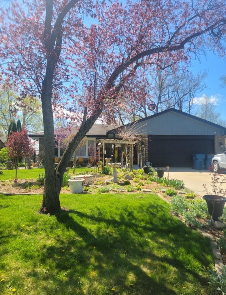 a front view of house with yard and green space