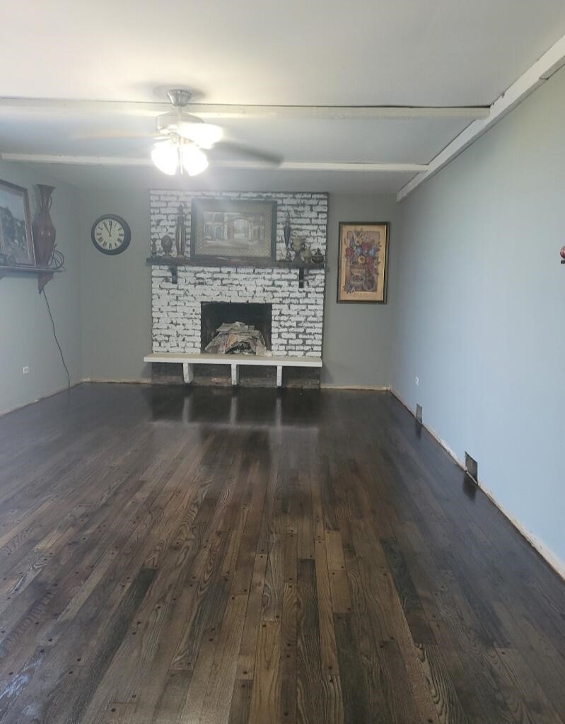 116 Alpine Lane Crete, IL 60417 - Photo 8 of 19 an empty room with wooden floor and fireplace