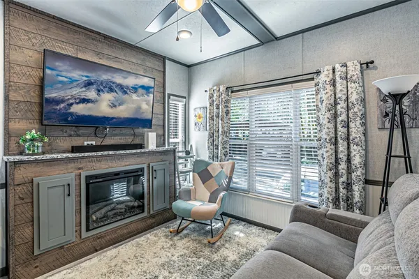 a living room with furniture a fireplace and a flat screen tv