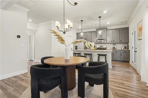 a kitchen with sink refrigerator and dining table