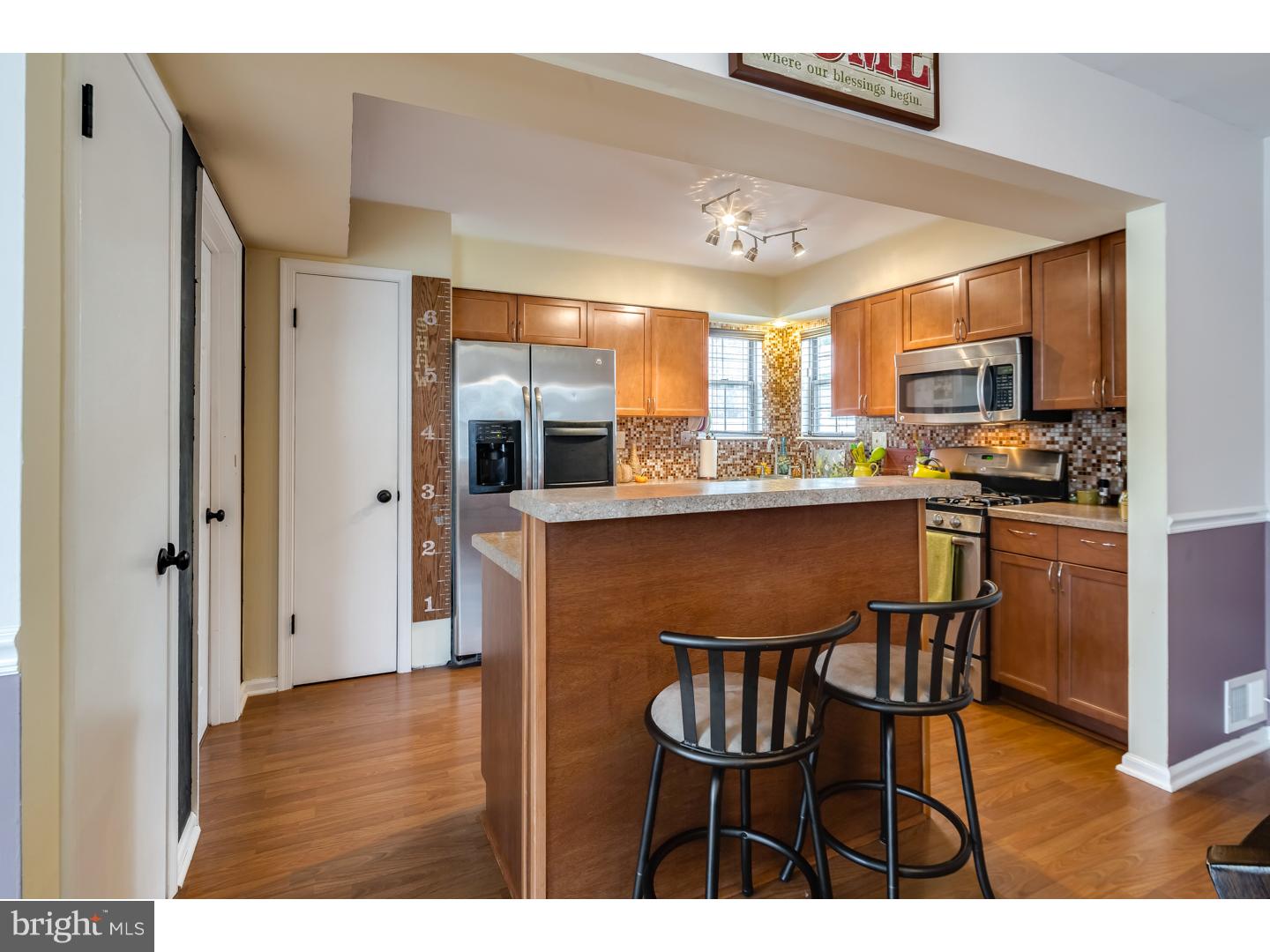 12 Derby Road Logan Township, NJ 08085 - Photo 8 of 23 a kitchen with stainless steel appliances granite countertop a table chairs refrigerator and a sink