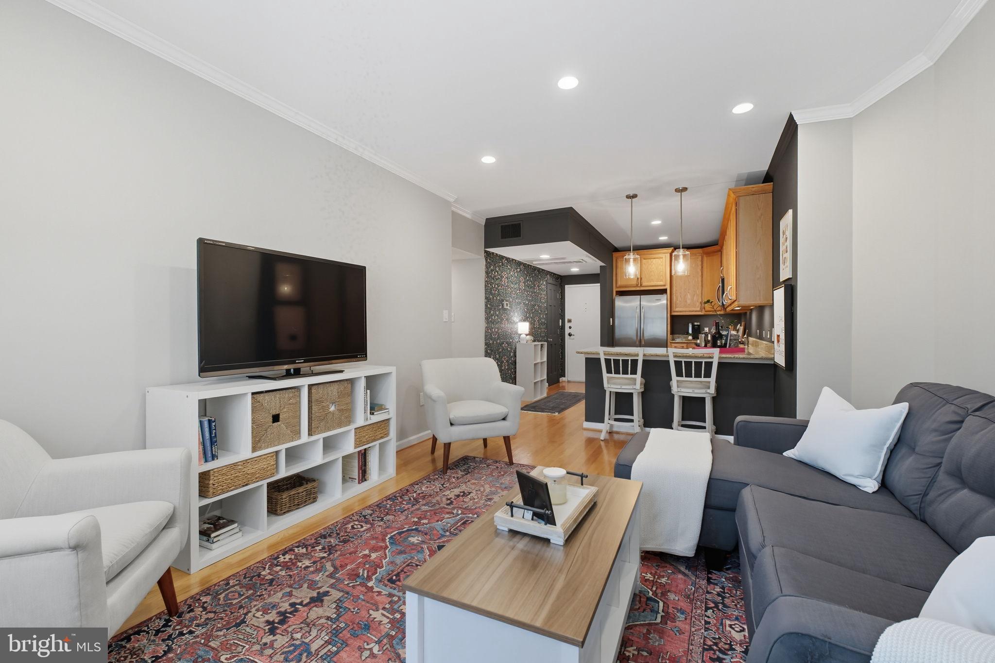1669 Columbia Road Northwest, Unit 203 Washington, DC 20009 - Photo 10 of 18 a living room with furniture and a flat screen tv