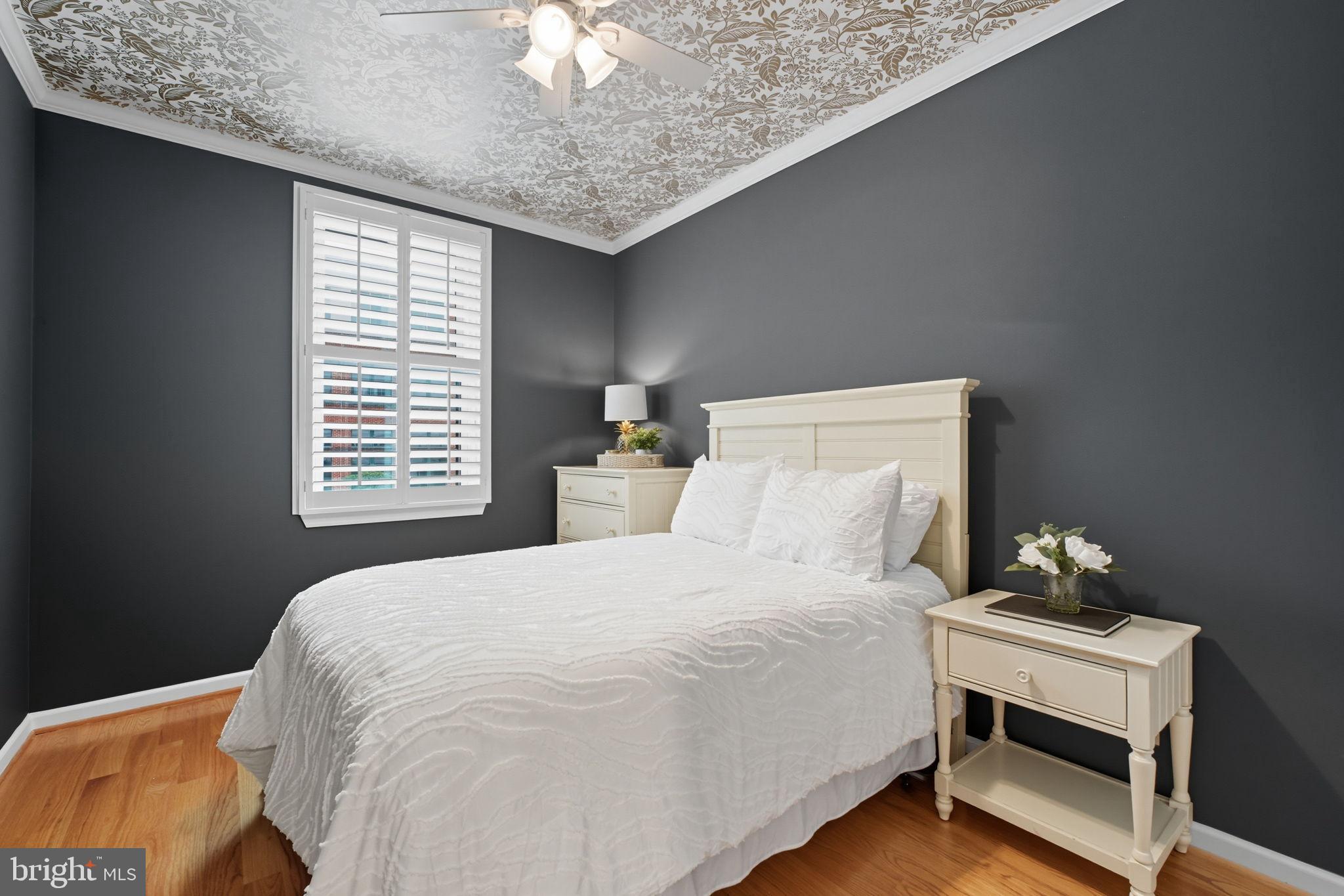 1669 Columbia Road Northwest, Unit 203 Washington, DC 20009 - Photo 12 of 18 a bedroom with a bed and a chandelier
