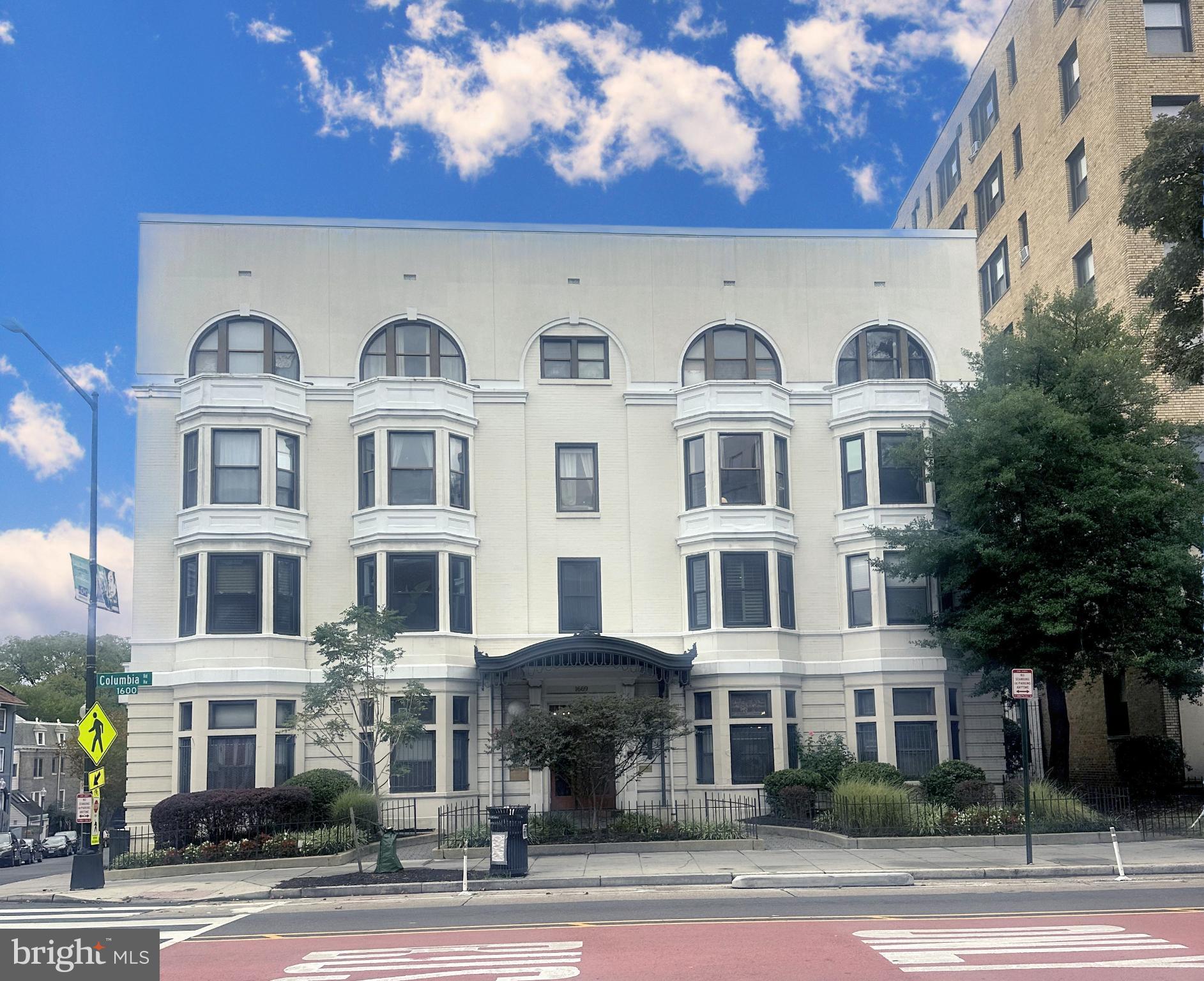 1669 Columbia Road Northwest, Unit 203 Washington, DC 20009 - Photo 15 of 18 a front view of a building with a yard
