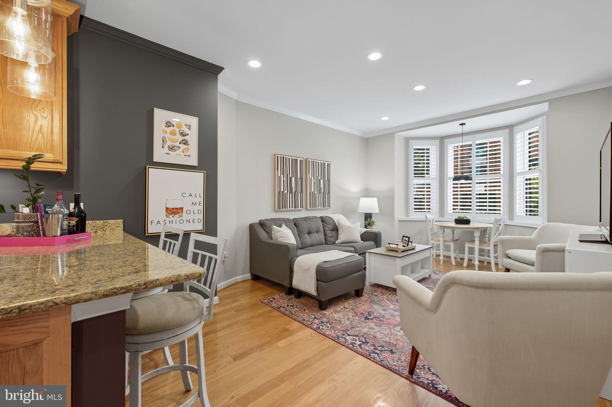 1669 Columbia Road Northwest, Unit 203 Washington, DC 20009 - Photo 6 of 18 a living room with furniture and a large window
