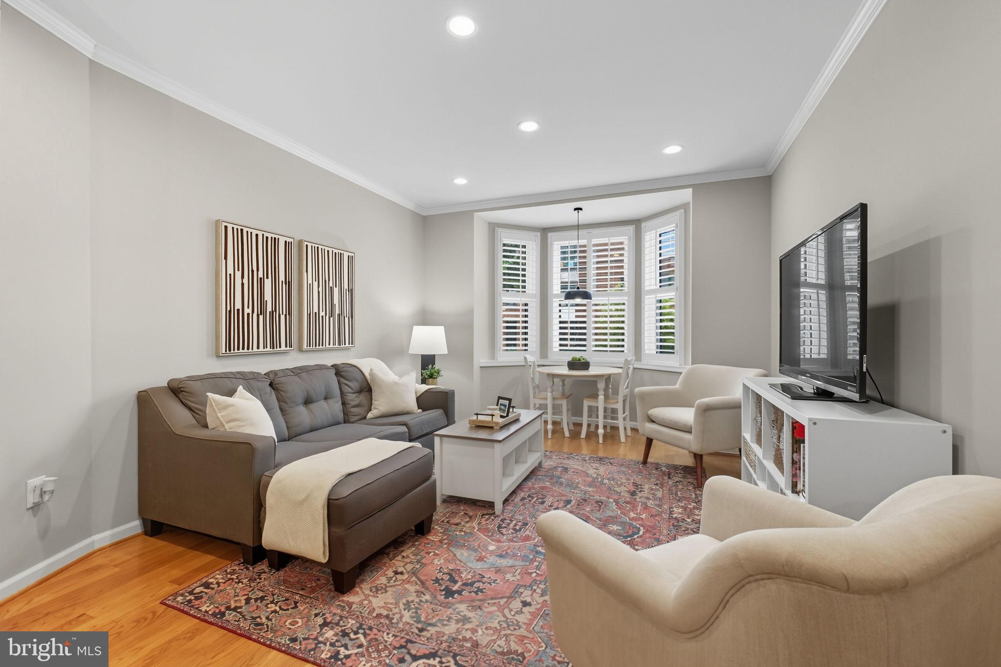 1669 Columbia Road Northwest, Unit 203 Washington, DC 20009 - Photo 7 of 18 a living room with furniture and a flat screen tv