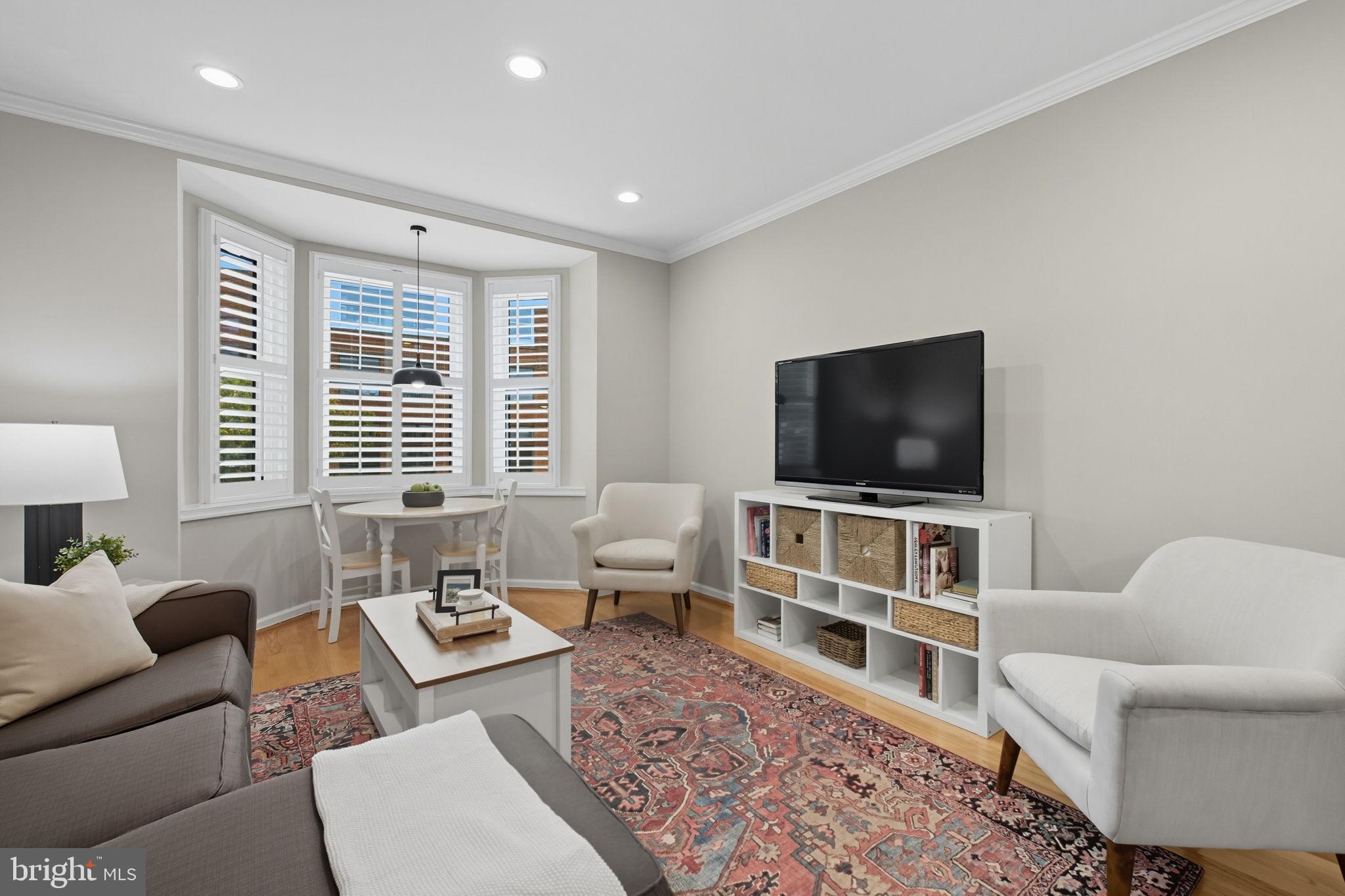 1669 Columbia Road Northwest, Unit 203 Washington, DC 20009 - Photo 8 of 18 a living room with furniture and a flat screen tv