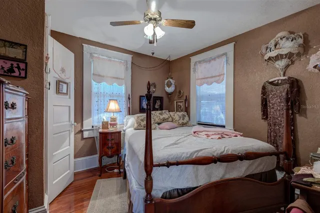 a bedroom with a bed and a chandelier