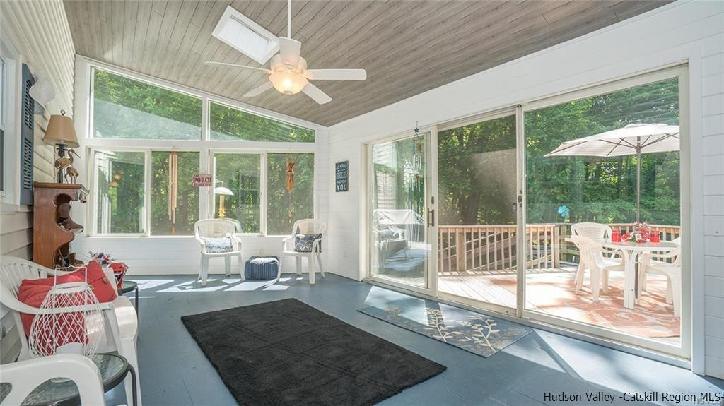 20 Van Orden Road Milton, NY 12547 - Photo 11 of 32 a living room with a large white floor to ceiling window and outdoor kitchen
