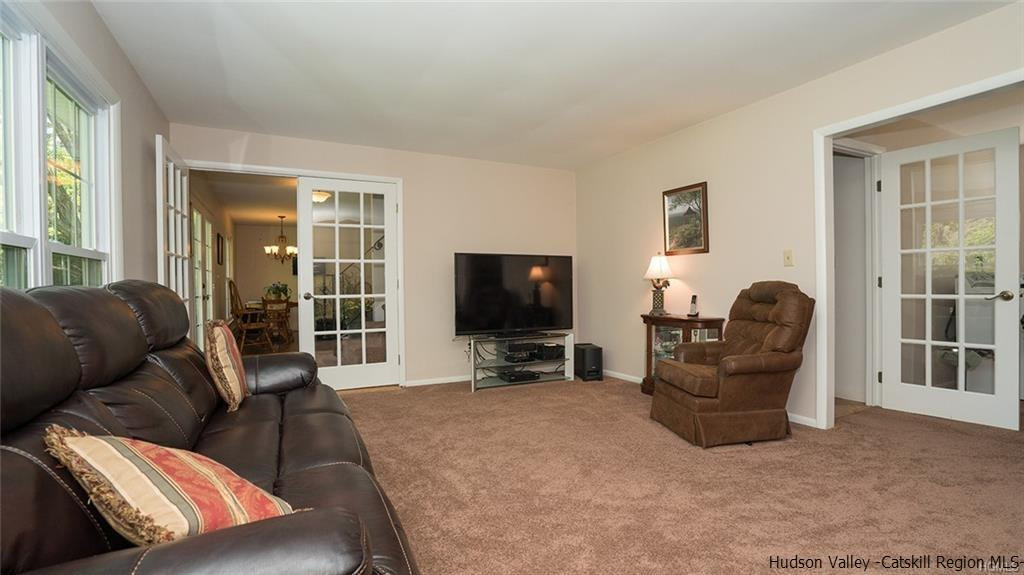 20 Van Orden Road Milton, NY 12547 - Photo 13 of 32 a living room with furniture a flat screen tv and a large window