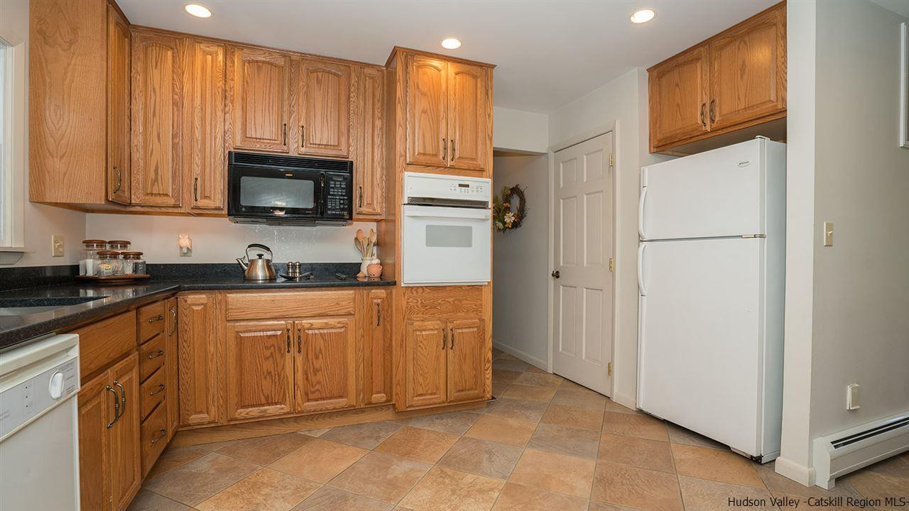 20 Van Orden Road Milton, NY 12547 - Photo 8 of 32 a kitchen with stainless steel appliances granite countertop a refrigerator stove a sink and dishwasher with wooden cabinet