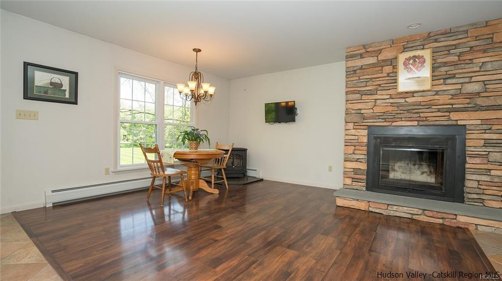 20 Van Orden Road Milton, NY 12547 - Photo 9 of 32 a dining room with furniture a fireplace and wooden floor