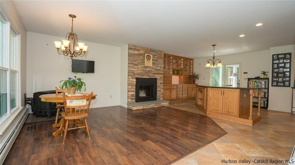 20 Van Orden Road Milton, NY 12547 - Photo 10 of 32 a dining room with wooden floor a chandelier a wooden table and chairs
