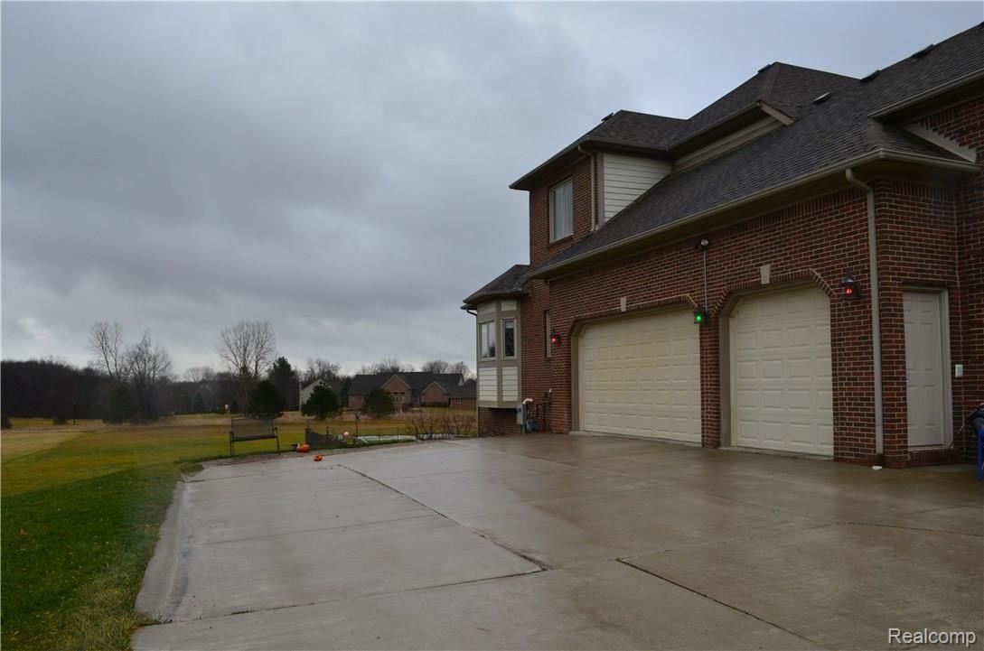 67808 Campground Road Washington, MI 48095 - Photo 4 of 77 HOME EXTERIOR - 3 CAR GARAGE