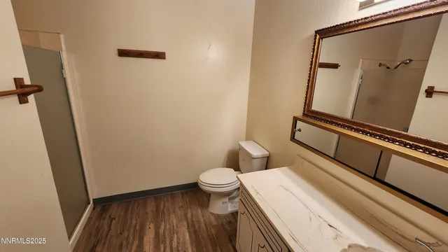a bathroom with a toilet and a shower