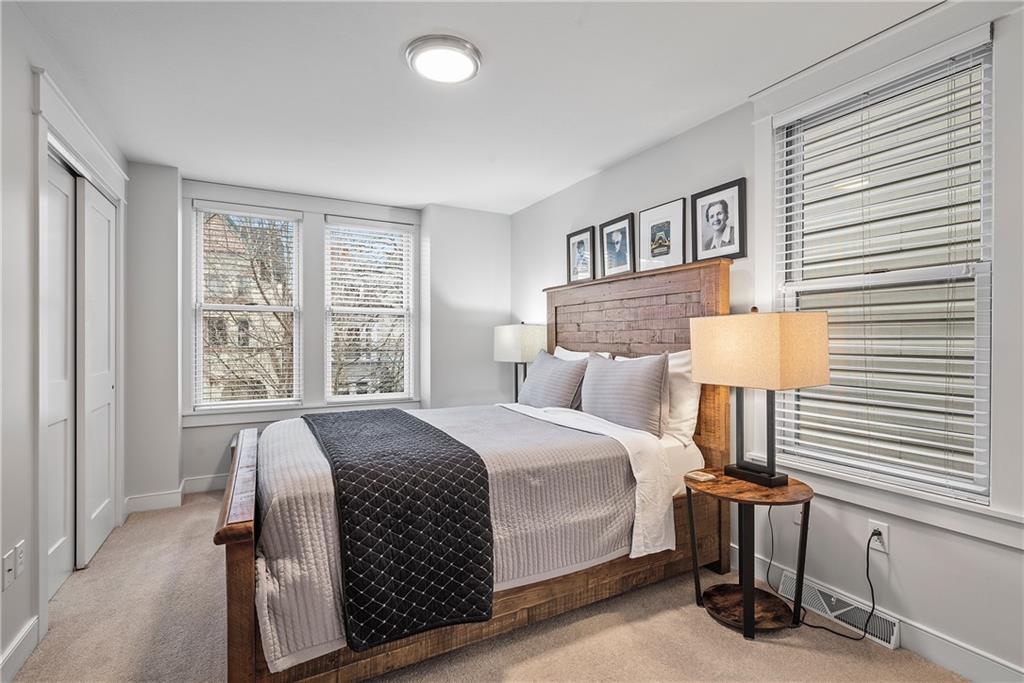 706 Ivy Street, Unit 1 Pittsburgh, PA 15232 - Photo 22 of 35 a bedroom with a bed and a lamp on table window