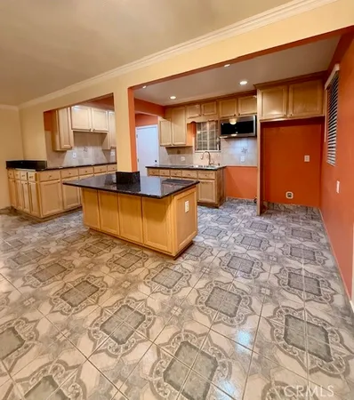 a view of kitchen with kitchen island dining room and granite counter top