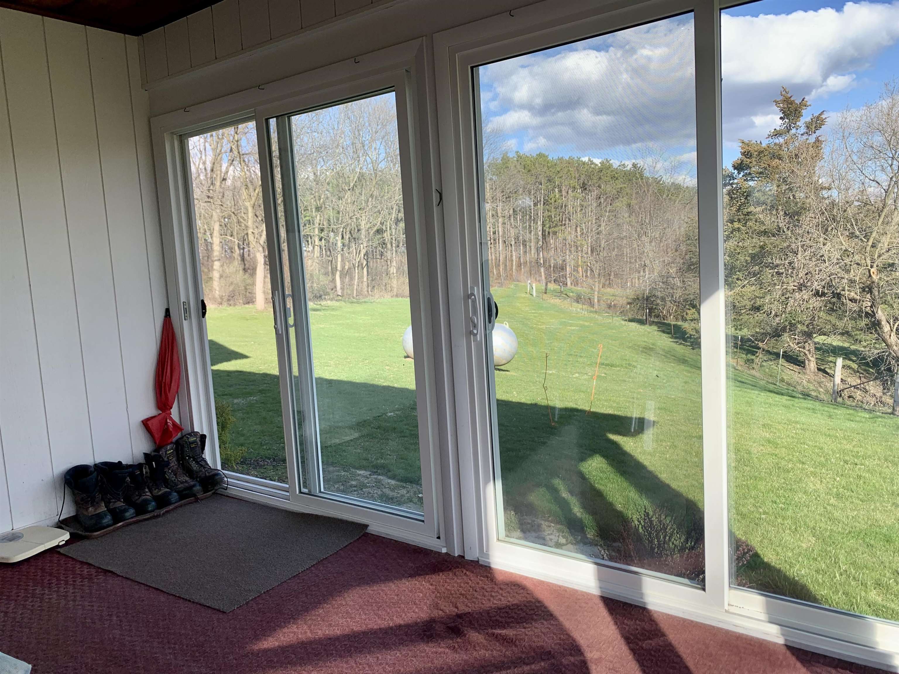 6569 South Speer Road Hanover, IL 61041 - Photo 19 of 59 a living room with a floor to ceiling window and a yard