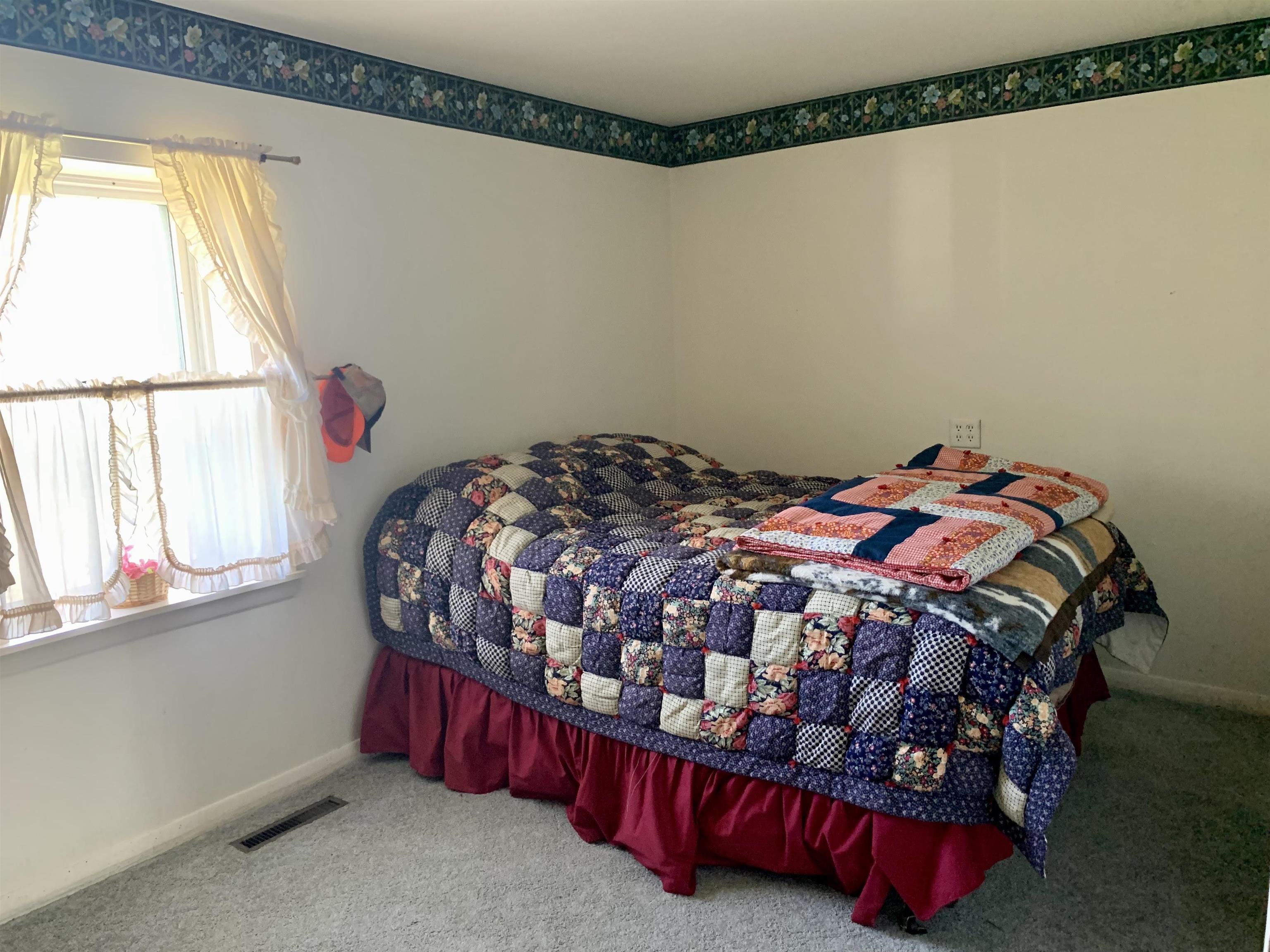 6569 South Speer Road Hanover, IL 61041 - Photo 21 of 59 a bedroom with a bed and a window