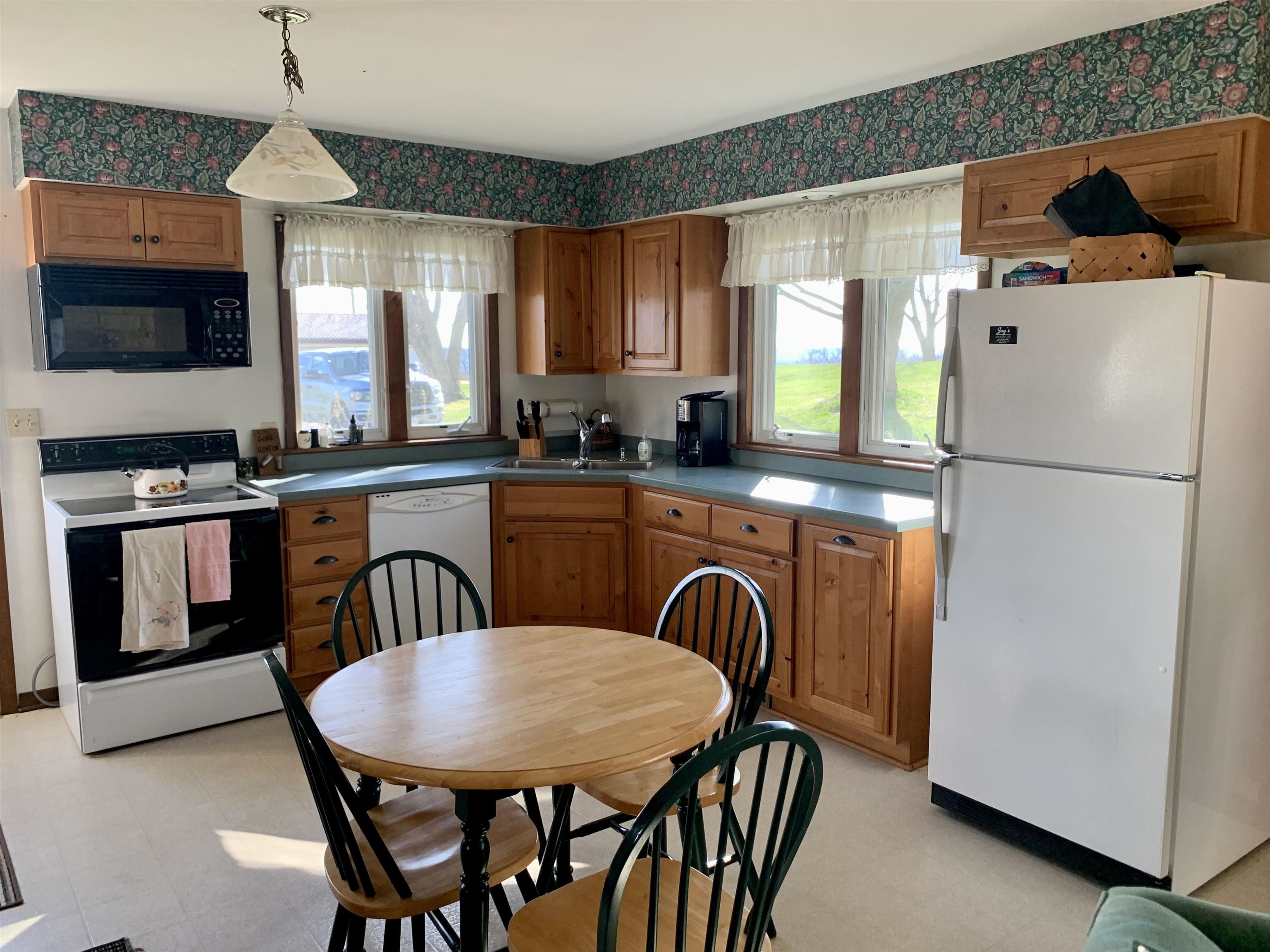 6569 South Speer Road Hanover, IL 61041 - Photo 10 of 59 a kitchen with stainless steel appliances granite countertop a stove a refrigerator a sink a dining table and chairs