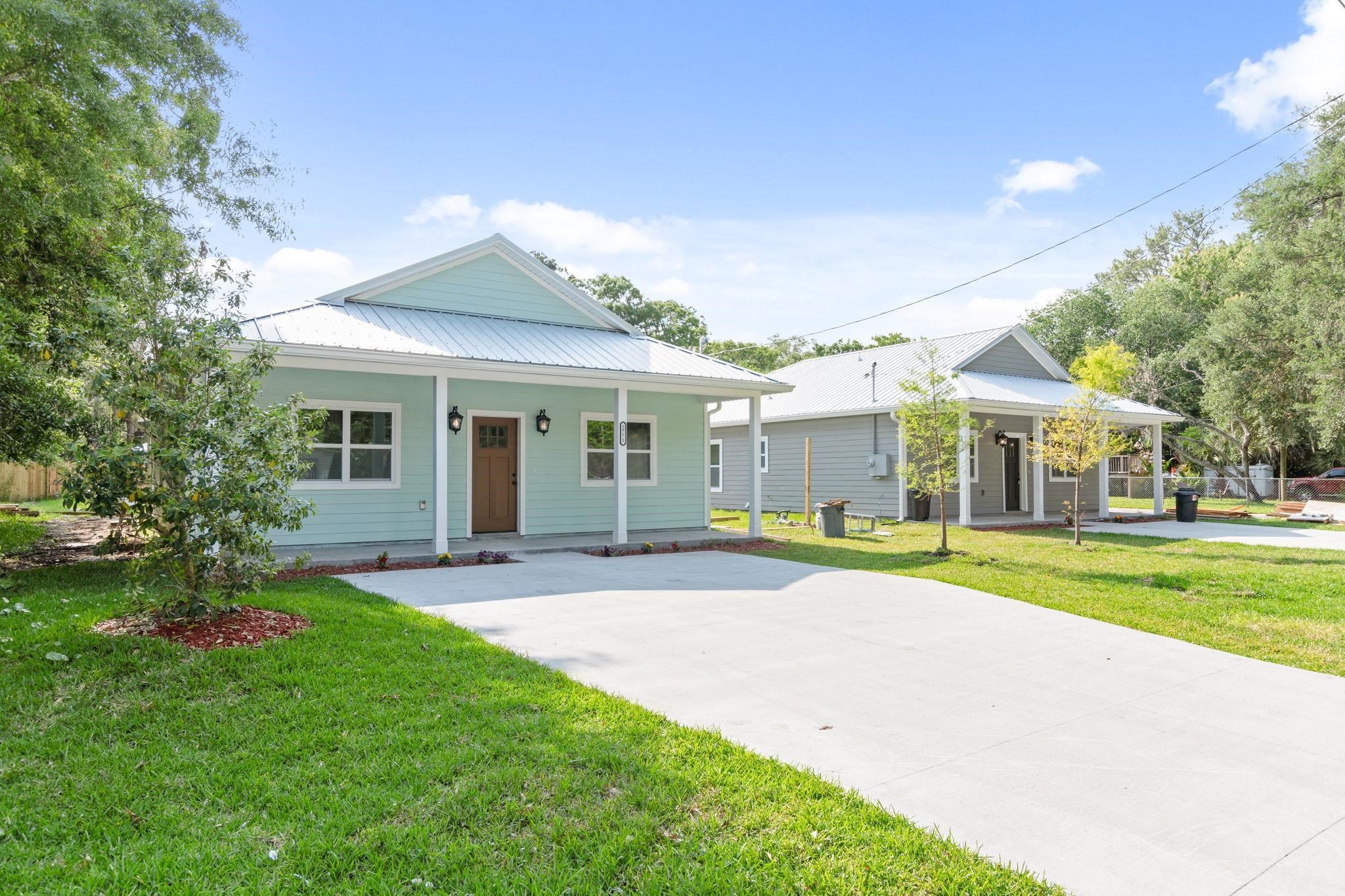 a view of a house with a yard and porch