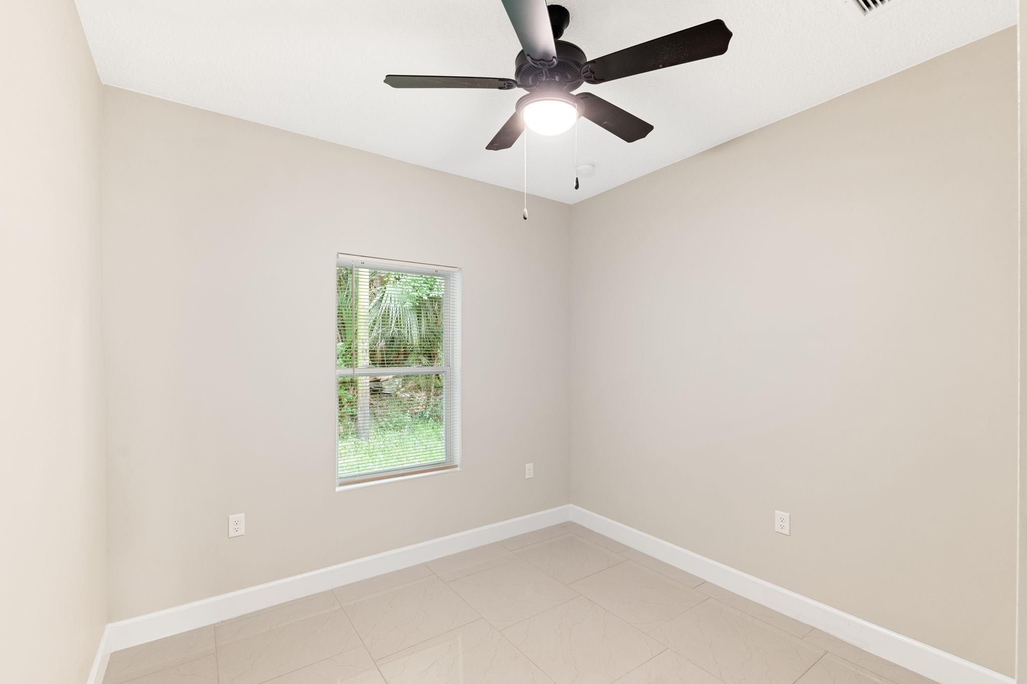 2770 Schaller Road St. Augustine, FL 32084 - Photo 18 of 29 an empty room with a window and a fan