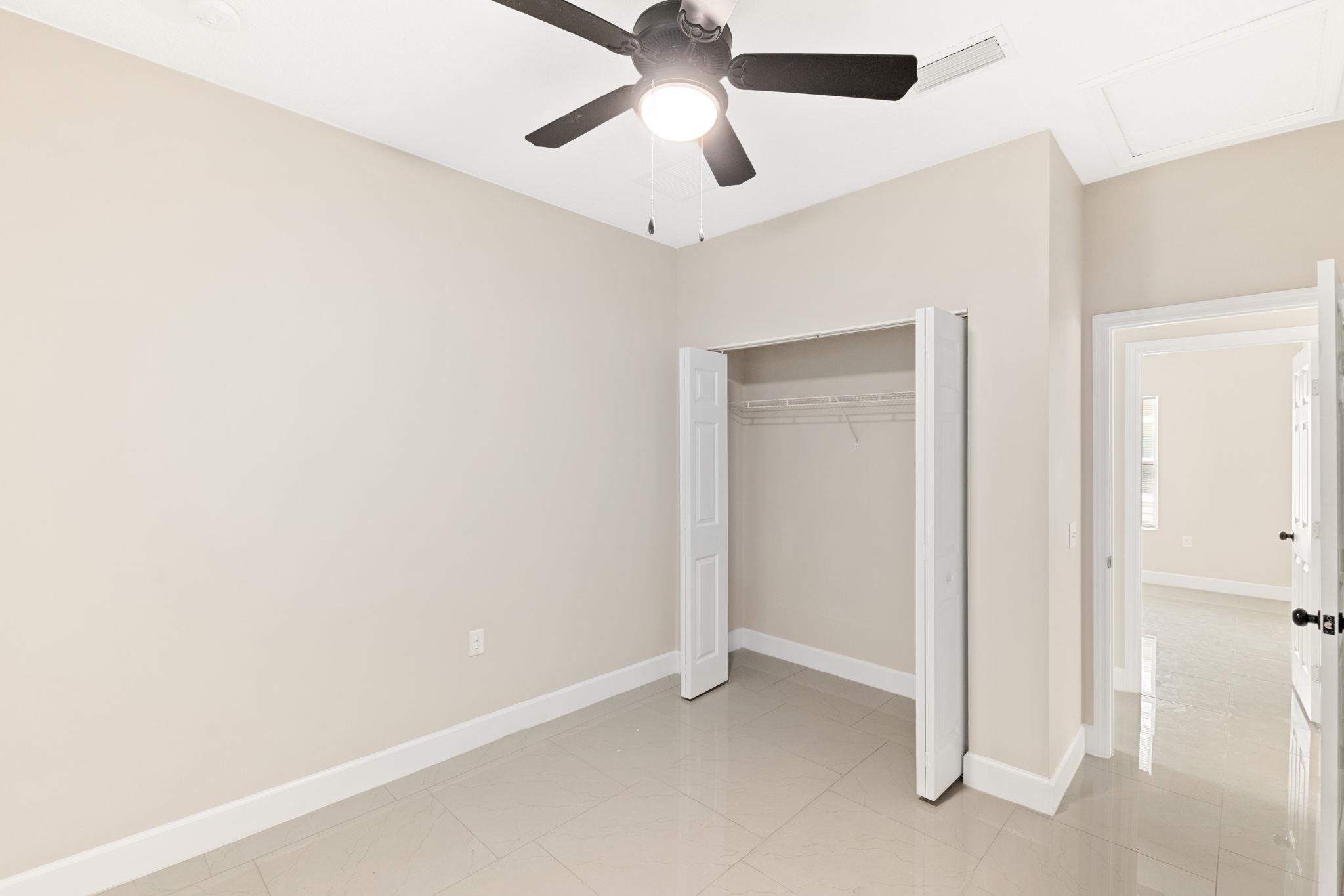 2770 Schaller Road St. Augustine, FL 32084 - Photo 19 of 29 an empty room with a ceiling fan and carpet