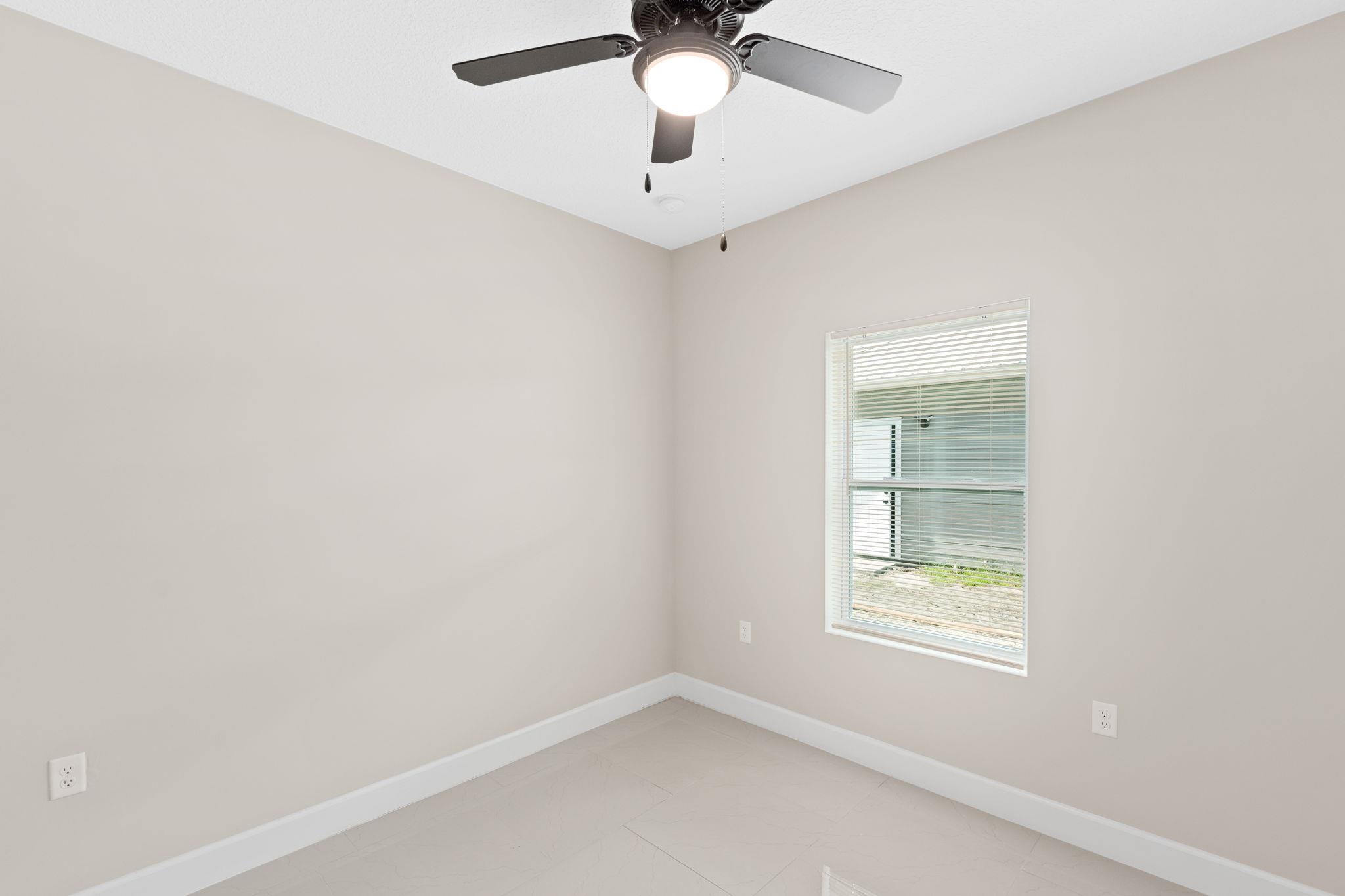 2770 Schaller Road St. Augustine, FL 32084 - Photo 20 of 29 an empty room with a window and a fan
