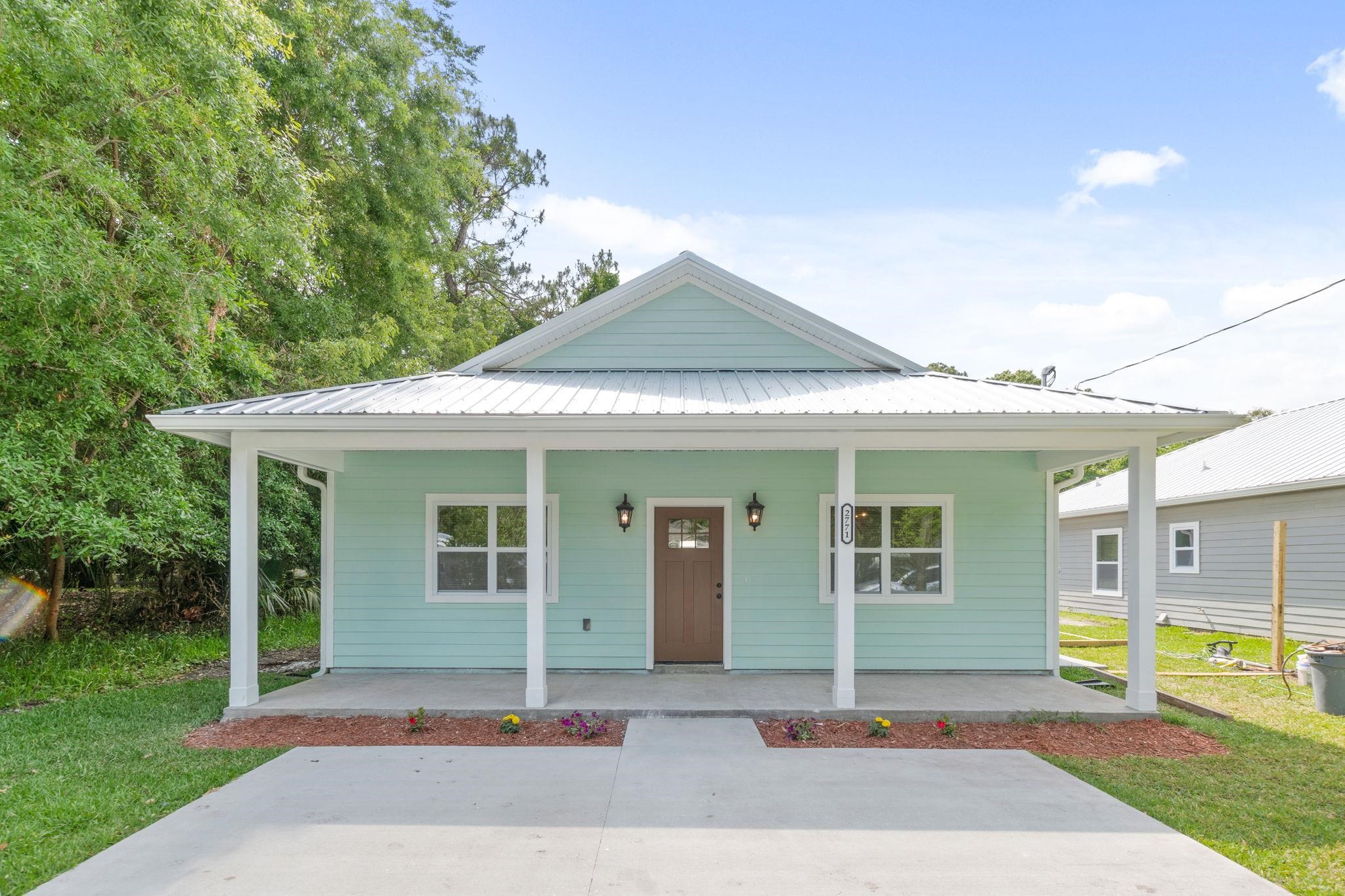 2770 Schaller Road St. Augustine, FL 32084 - Photo 2 of 29 a front view of a house with a yard and potted plants