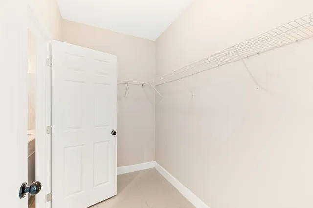a bathroom with a granite countertop sink a toilet and a mirror