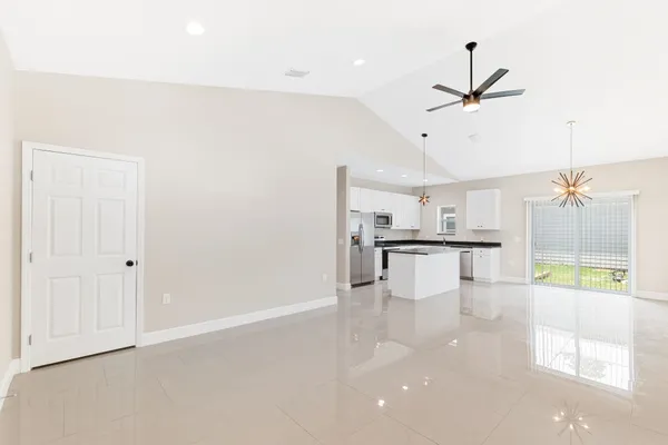 a view of kitchen with furniture and refrigerator