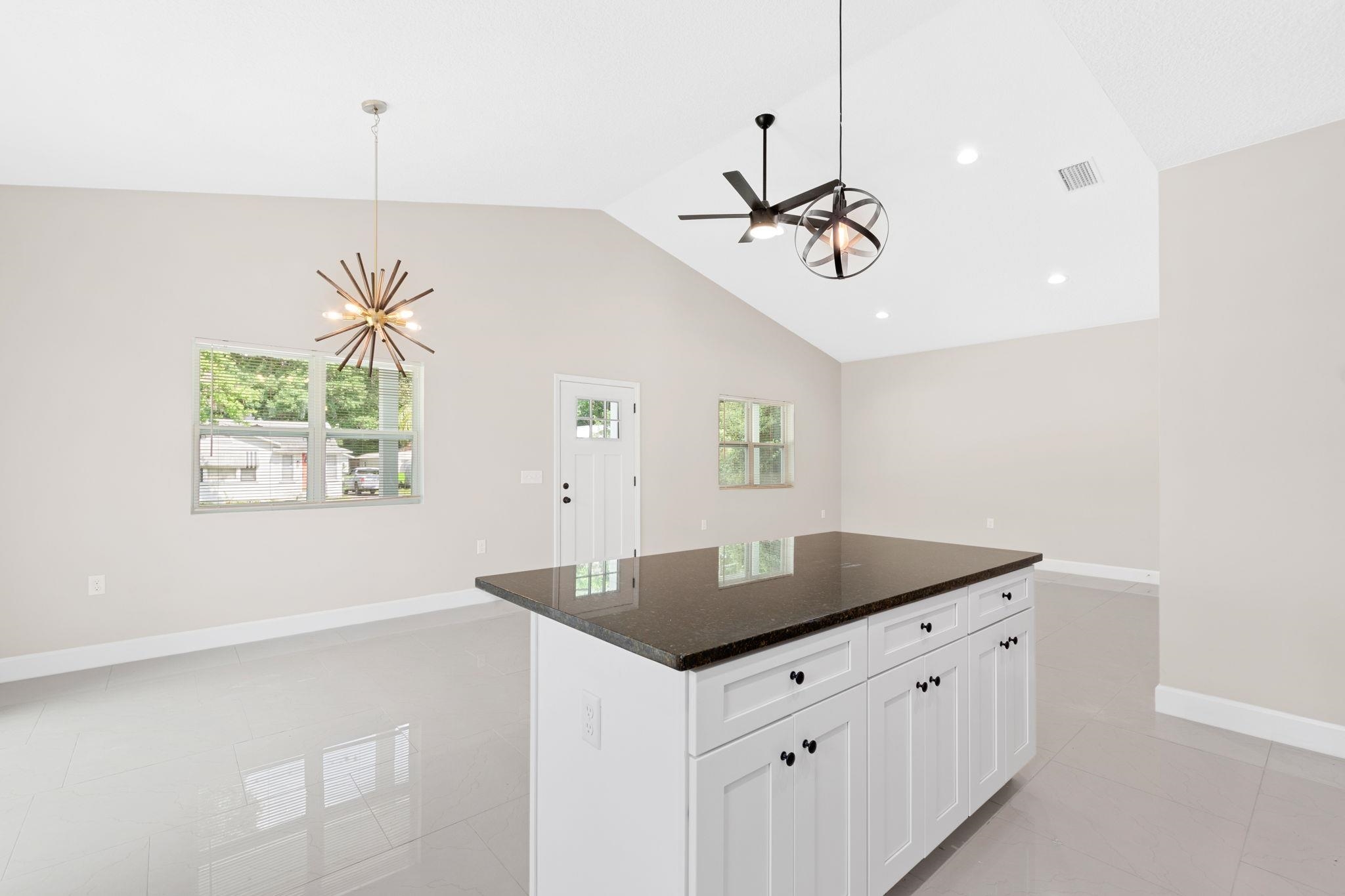 2770 Schaller Road St. Augustine, FL 32084 - Photo 10 of 29 a kitchen with stainless steel appliances granite countertop a sink a window and a refrigerator