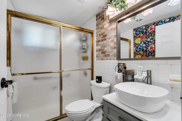 a white toilet sitting next to a bathroom sink