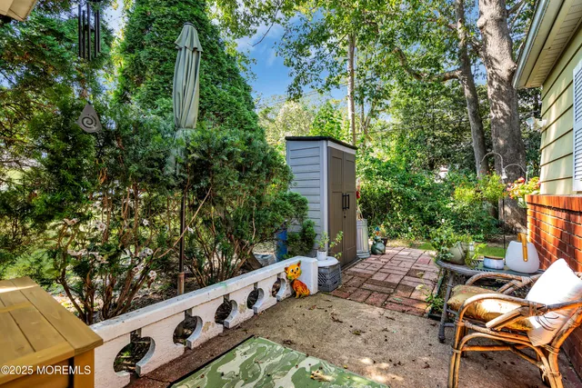 a view of a wooden bench under an umbrella
