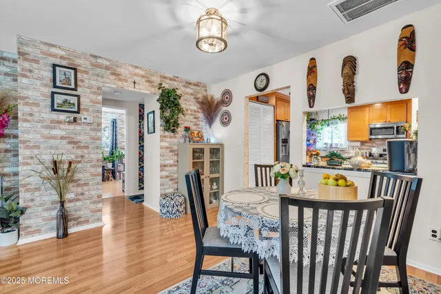 a view of a dining room with furniture and a floor to ceiling window