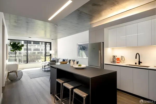 a kitchen with a sink cabinets and wooden floor