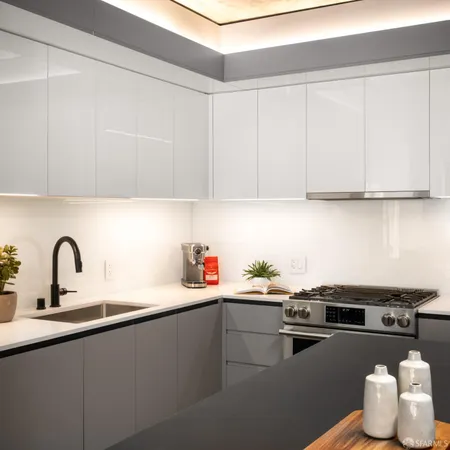 a kitchen with a sink cabinets and appliances