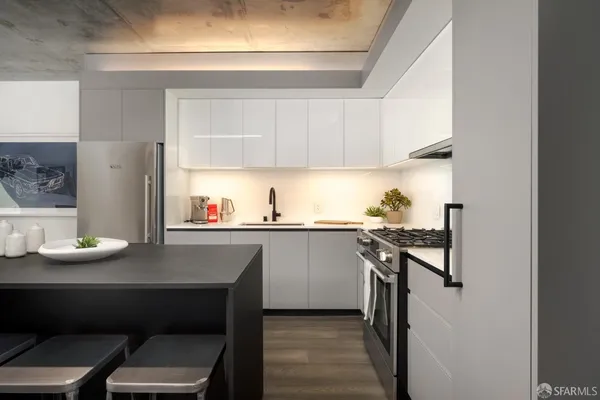 a kitchen with a sink appliances and cabinets
