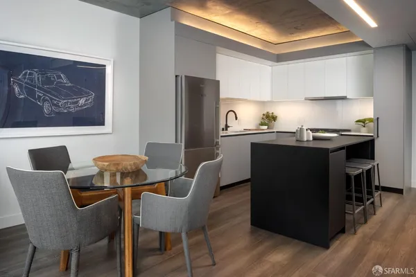 a dining room with furniture and wooden floor