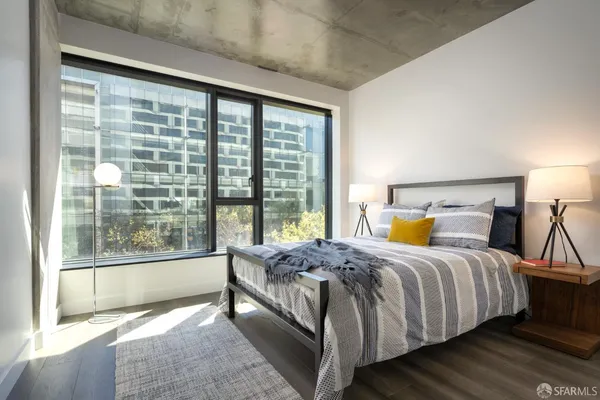 a bedroom with a large bed and a large window
