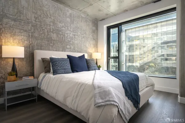 a bedroom with a bed and a large window