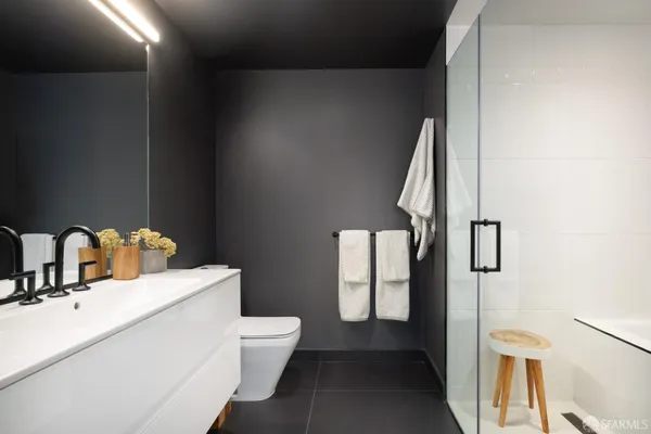 a bathroom with a toilet sink and mirror