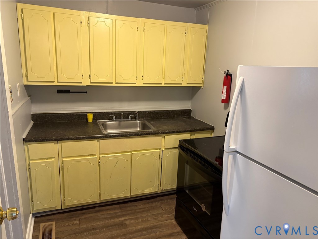 1904 Arlington Road Hopewell, VA 23860 - Photo 7 of 13 a kitchen with a sink a refrigerator and window