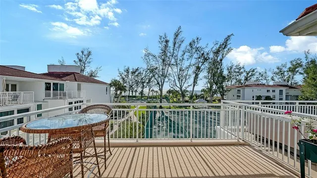 a view of backyard with swimming pool and seating space