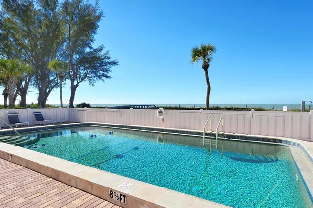 a view of a swimming pool with outdoor seating