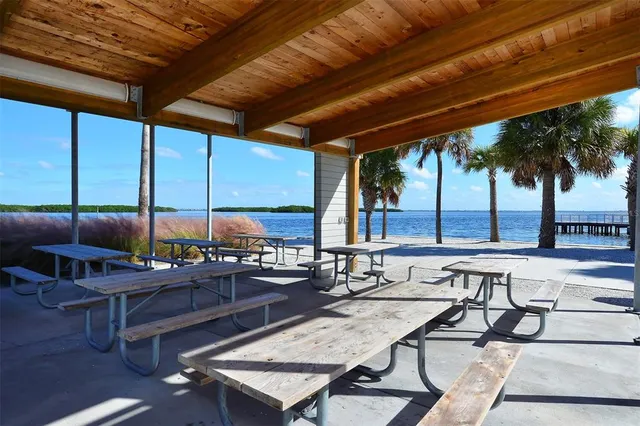 a view of a brick house with a big yard and large trees