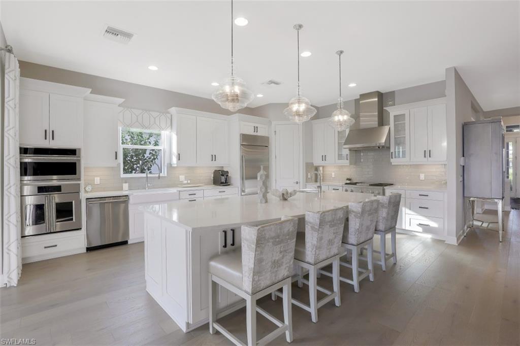 3258 Belon Lane Naples, FL 34114 - Photo 17 of 35 a large kitchen with a large counter top appliances and cabinets