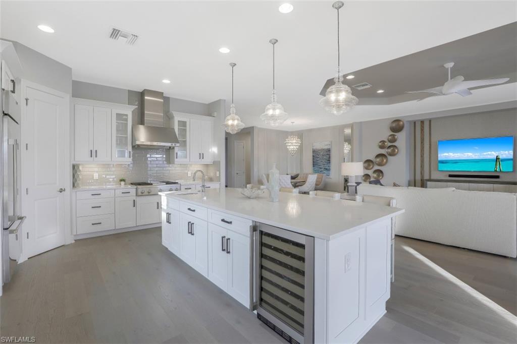 3258 Belon Lane Naples, FL 34114 - Photo 18 of 35 a kitchen with stainless steel appliances kitchen island granite countertop a sink and cabinets