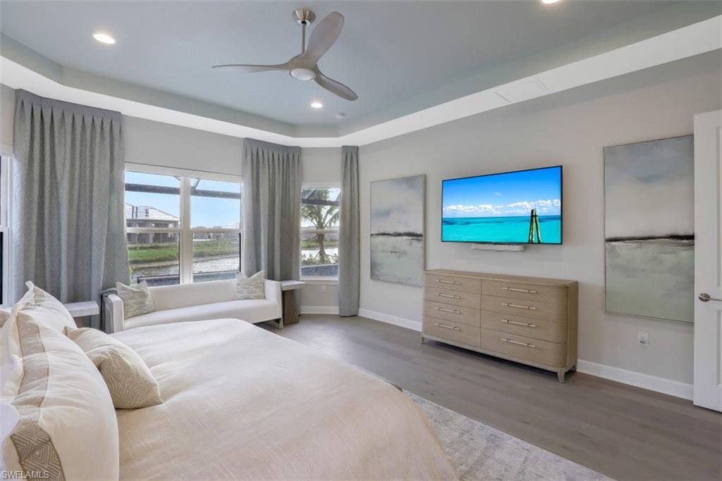 3258 Belon Lane Naples, FL 34114 - Photo 20 of 35 a bedroom with furniture and a flat screen tv
