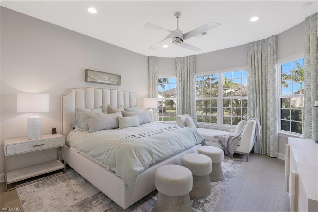 3258 Belon Lane Naples, FL 34114 - Photo 23 of 35 a bedroom with a bed and a large window